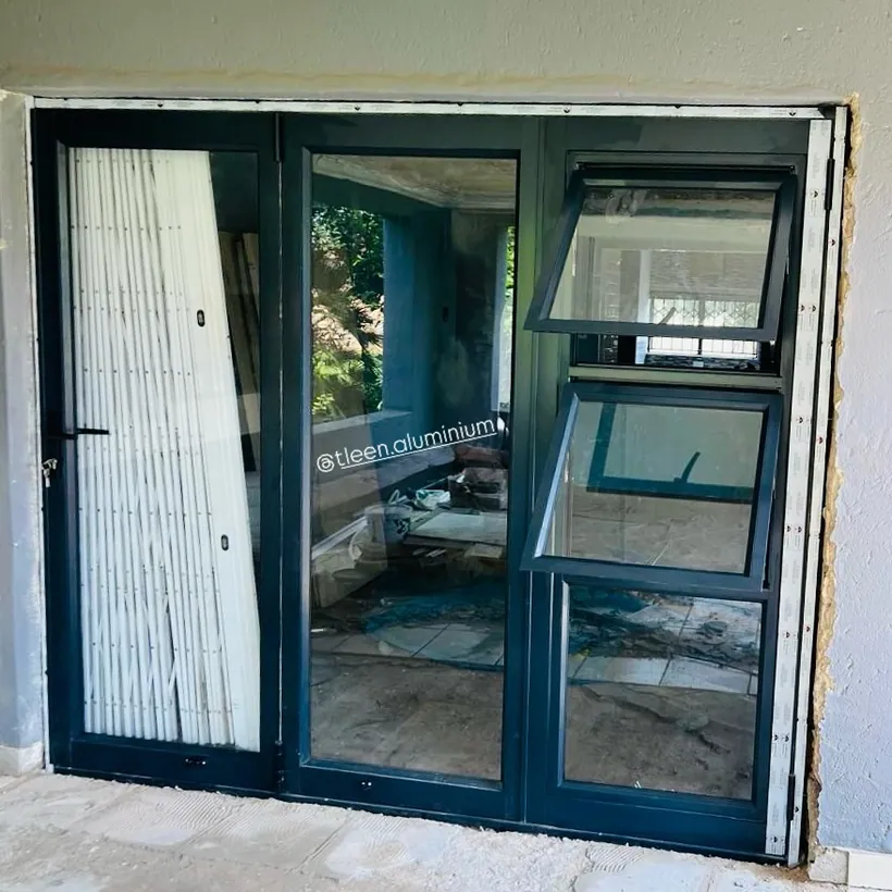 Charcoal aluminium door flanked by top-hung sidelight windows