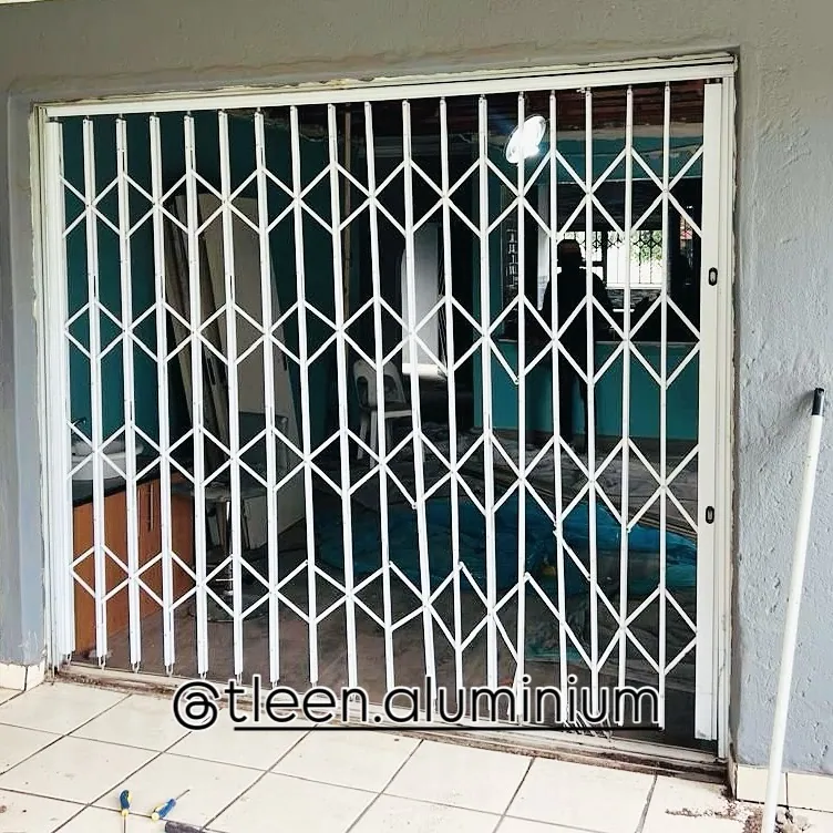 White trellis security gate fitted across a sliding door opening