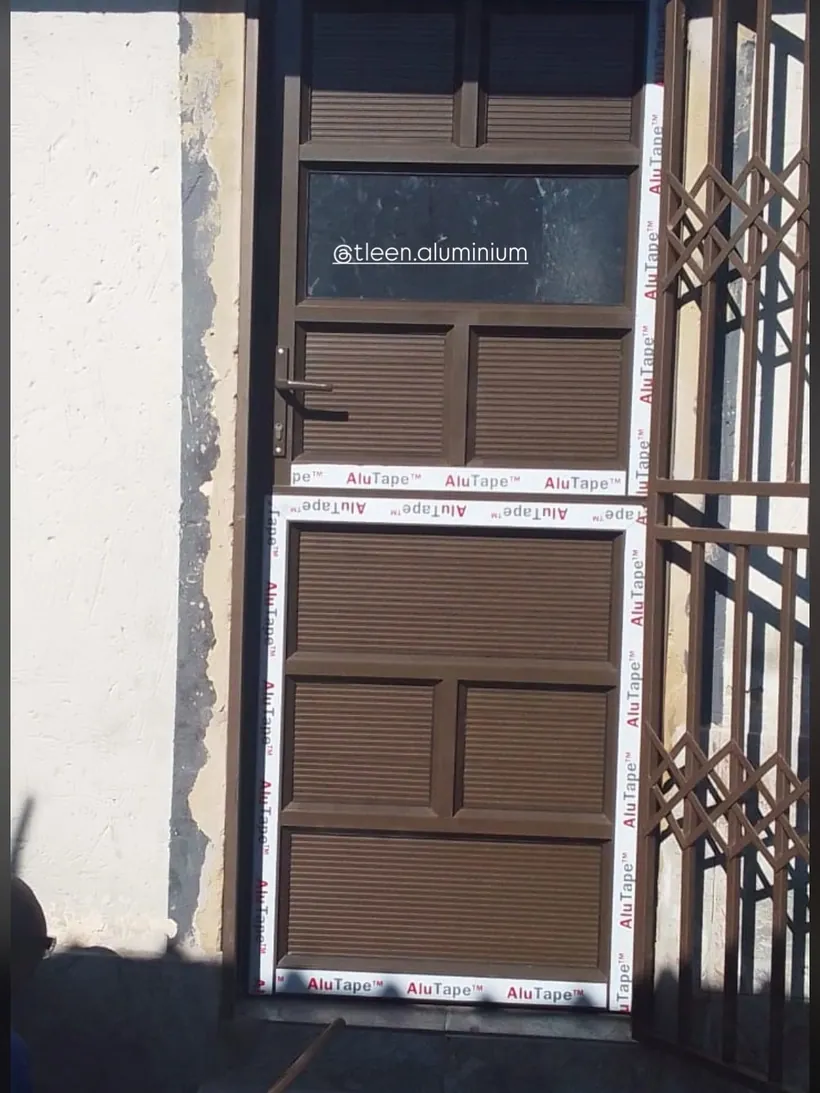Charcoal security gate and garage door on a residential elevation