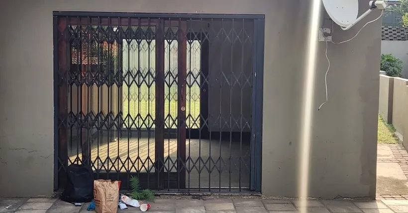 Trellis security gate fitted to a covered outdoor entrance
