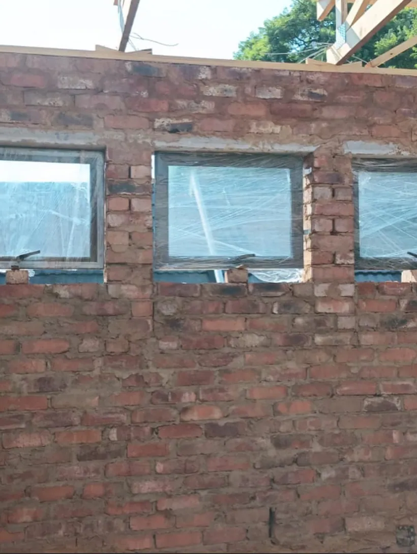 Charcoal top-hung windows fitted to a new-build brick elevation