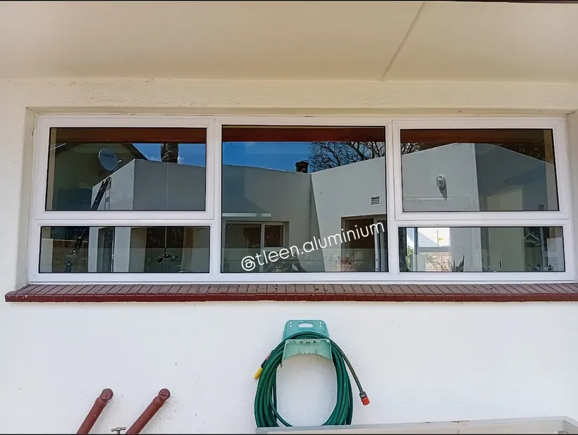 White aluminium side-hung and fixed window unit seen from inside