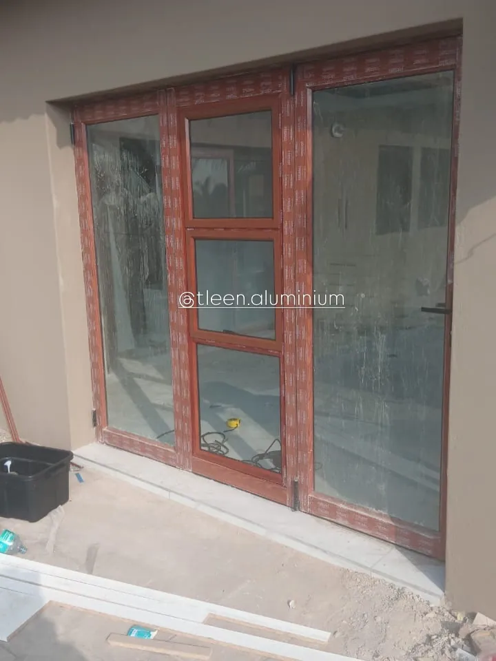 Small white top-hung window fitted into a face-brick opening