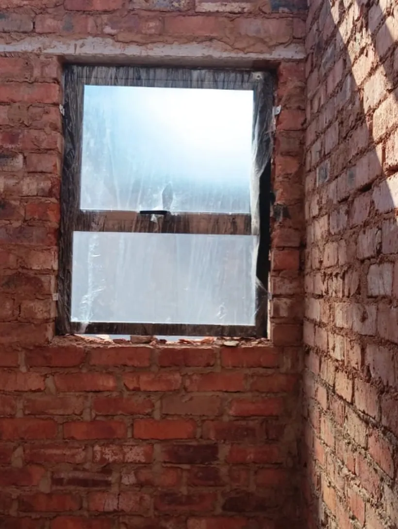 Large wood-look aluminium window unit with protective film still applied